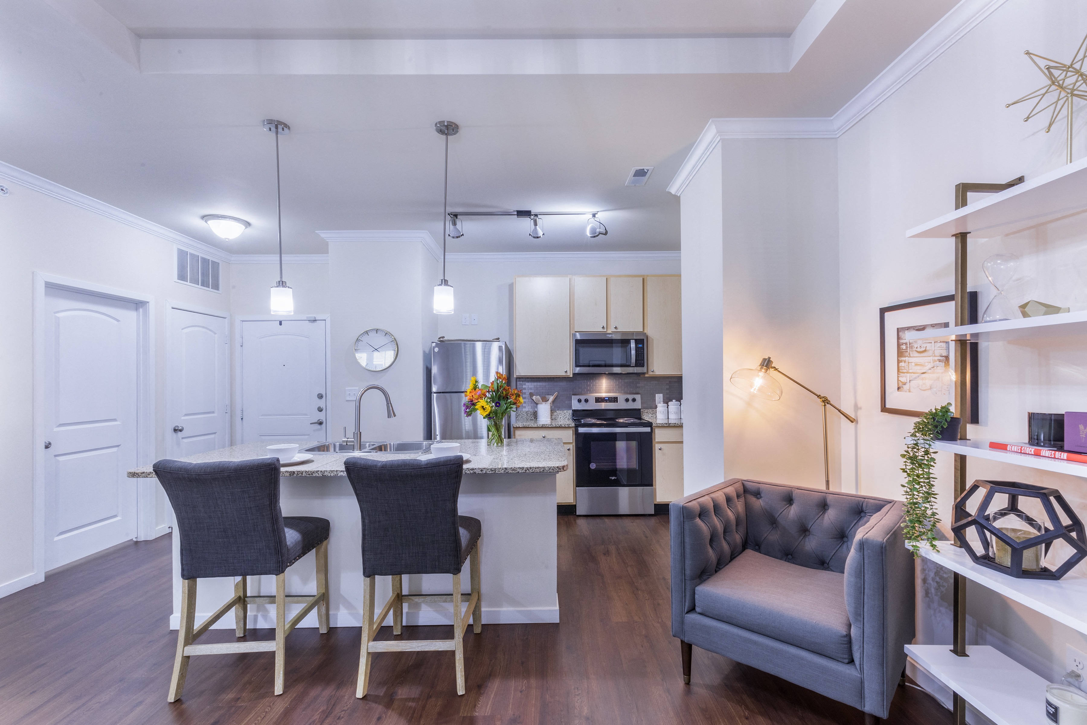 a living room with a kitchen and a couch and a table at Aventura at Forest Park, Missouri